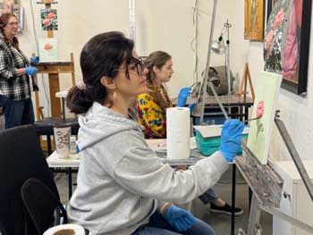 oil painting students paint at easels