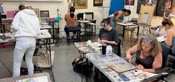 painting students working in fine art painting classroom