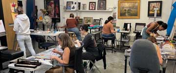 painting students working in fine art painting classroom