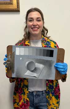 painting student shows her value scale in oil painting