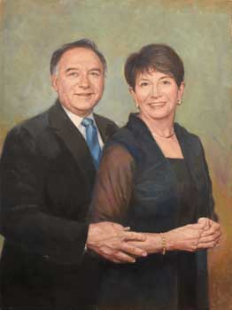 oil portrait of man and wife standing together in gentle embrace