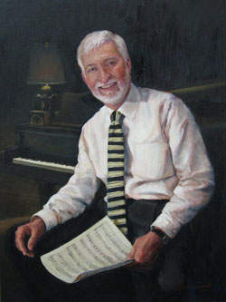 portrait of a man with white hair wearing a light pink shirt and a black striped tie in front of the keyboard of a piano